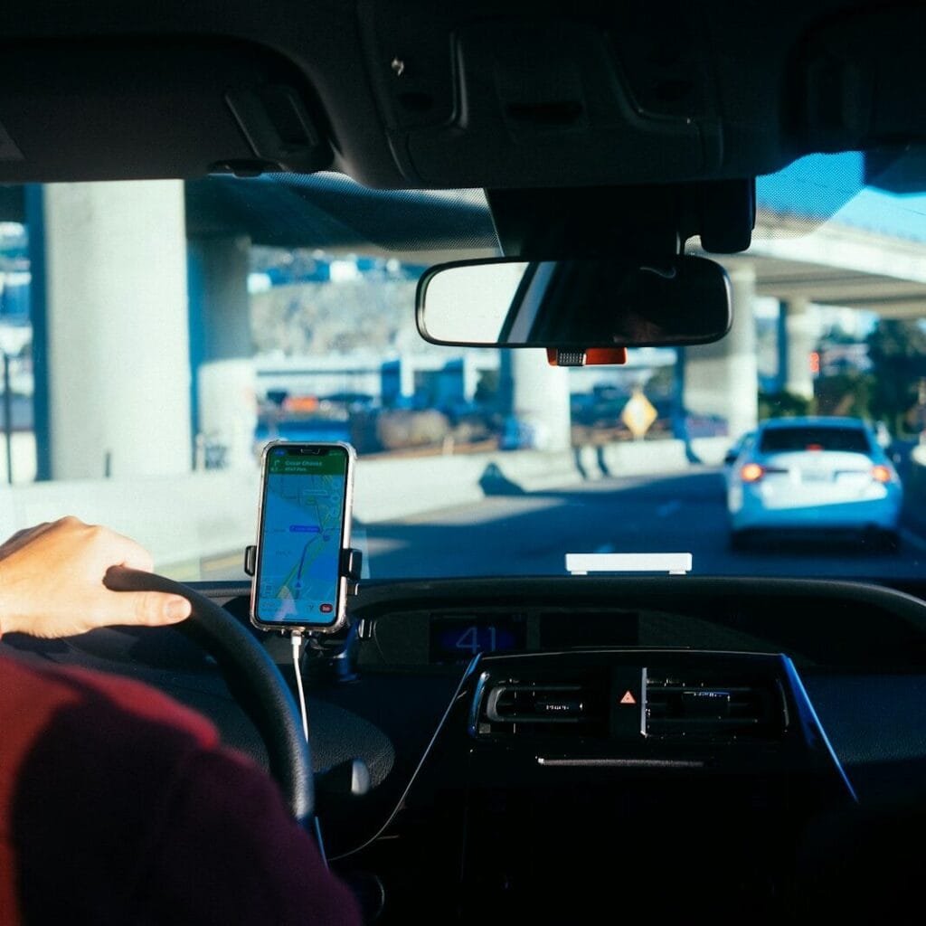 person holding iphone 6 inside car